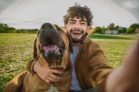 young happy man taking selfie with his dog in a pa 2021 11 10 20 34 50 utc